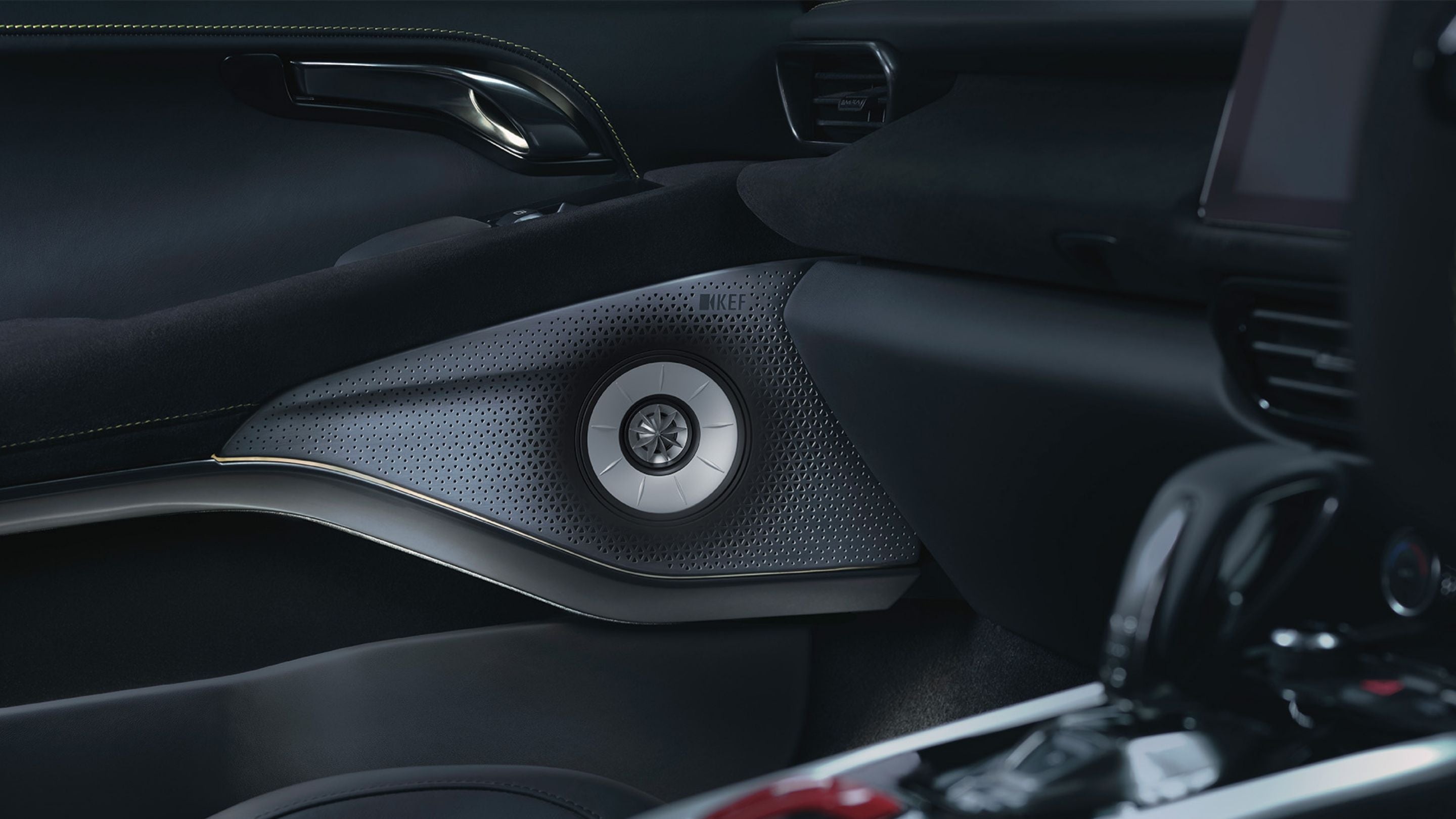 Close-up of a car's interior speaker and dashboard