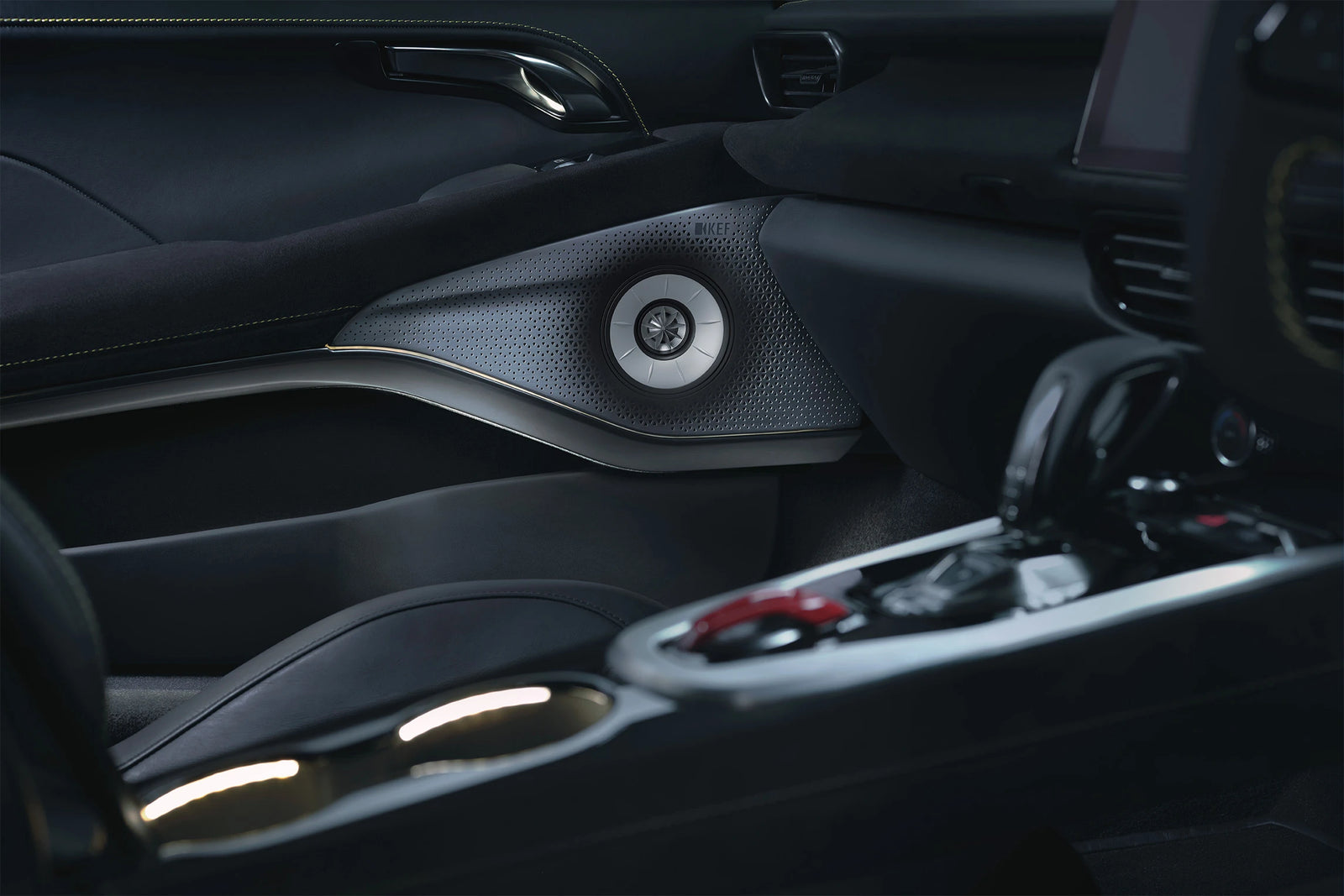 Close-up of a Lotus Emira car interior door panel with a KEF speaker and part of the center console.