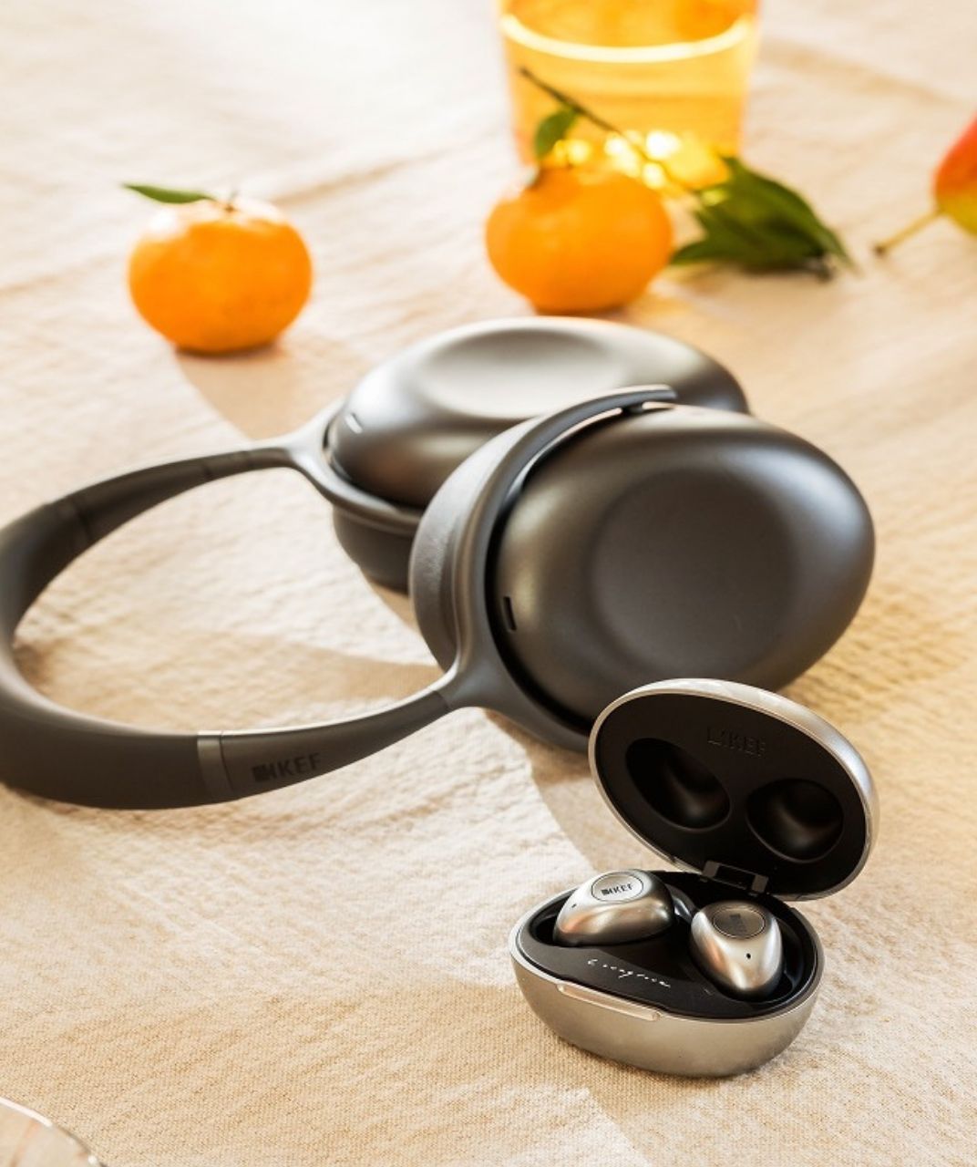 Mu7 and Mu3 headphones on table with oranges.